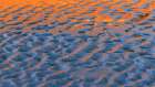 USA, Washington State, Copalis Beach. Reflection on beach sand at sunset. Art Print